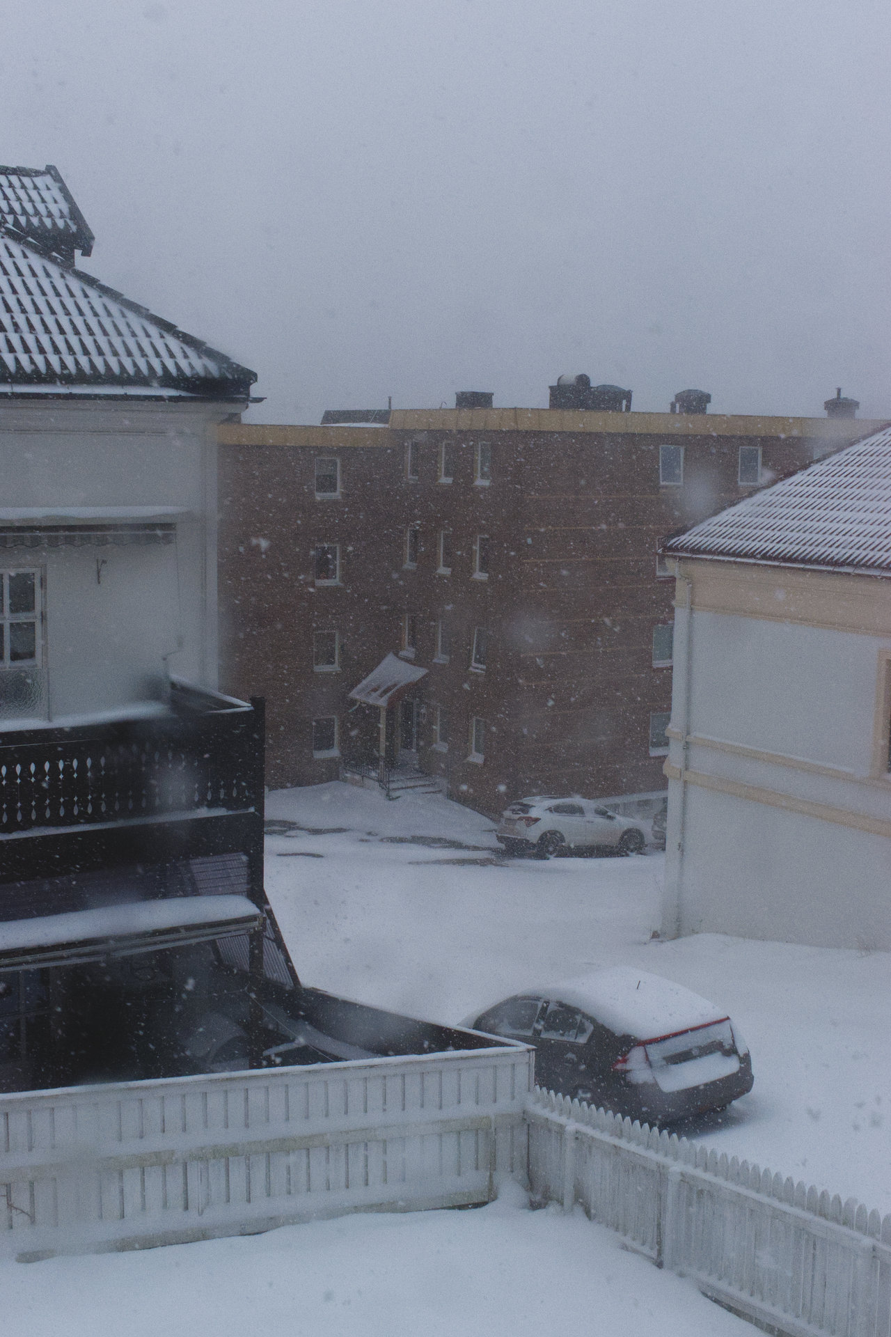 a photo of a short snowstorm in Larvik, the view is from the window